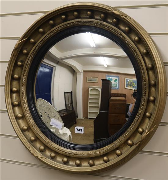 A Regency style gilt framed convex wall mirror, W.60cm